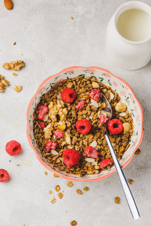 A plate with granola and raspberriesの写真素材