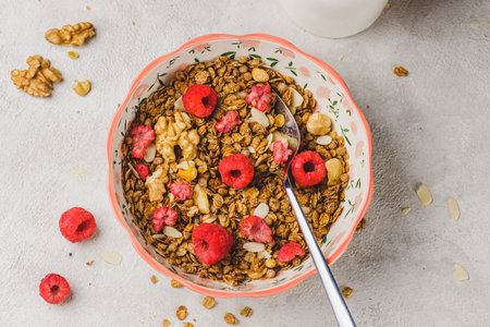 A plate with granola and raspberriesの写真素材