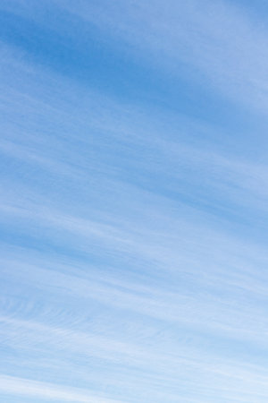 Long thin streaks of clouds in the blue skyの写真素材