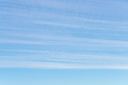 Long thin streaks of clouds in the blue sky