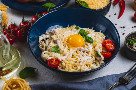 Pasta carbonara in a plate on the tableの写真素材