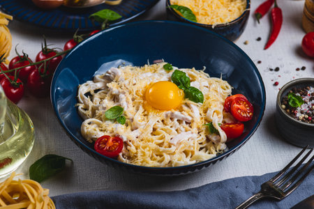 Pasta carbonara in a plate on the tableの写真素材