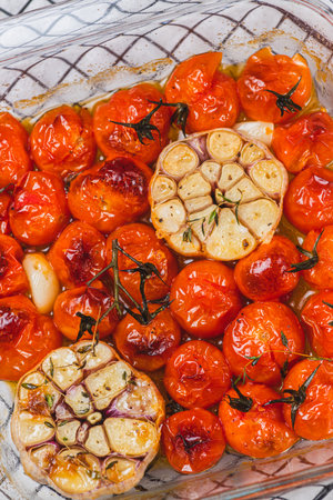 Cherry tomatoes baked with thyme and garlic cloveの写真素材