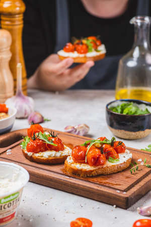 Bruschetta with ricotta and baked tomatoesの写真素材