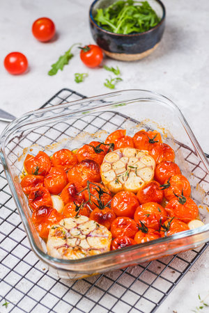 Cherry tomatoes baked with thyme and garlic cloveの写真素材