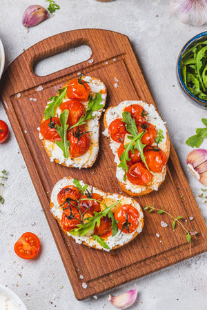 Bruschetta with ricotta and baked tomatoesの写真素材