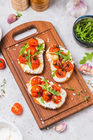 Bruschetta with ricotta and baked tomatoesの写真素材