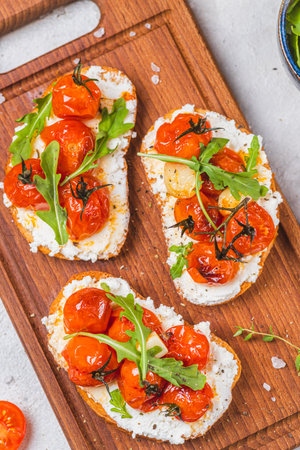 Bruschetta with ricotta and baked tomatoesの写真素材