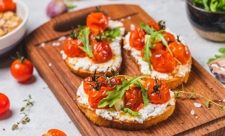Bruschetta with ricotta and baked tomatoesの写真素材