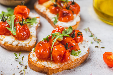 Bruschetta with ricotta and baked tomatoesの写真素材
