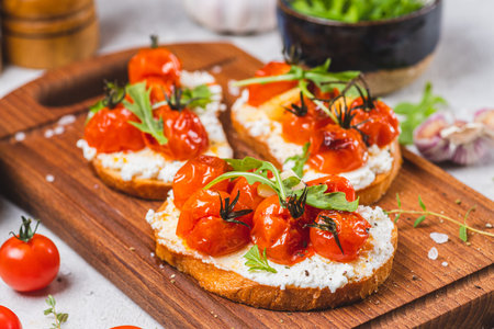 Bruschetta with ricotta and baked tomatoesの写真素材