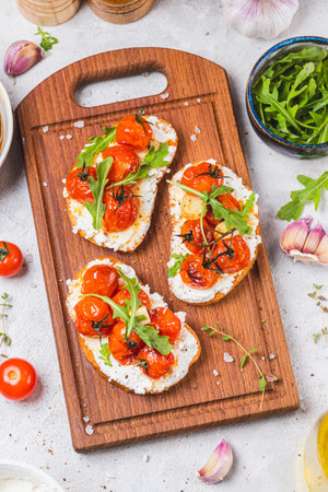 Bruschetta with ricotta and baked tomatoesの写真素材