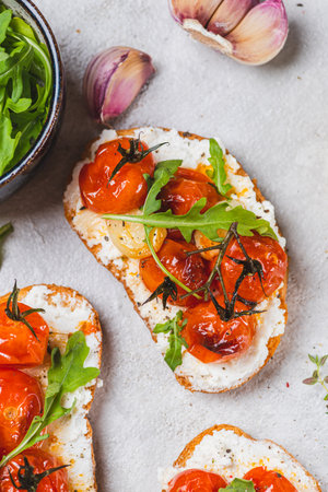 Bruschetta with ricotta and baked tomatoesの写真素材