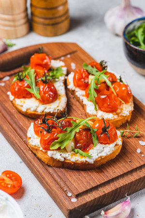 Bruschetta with ricotta and baked tomatoesの写真素材