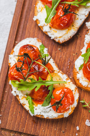 Bruschetta with ricotta and baked tomatoesの写真素材