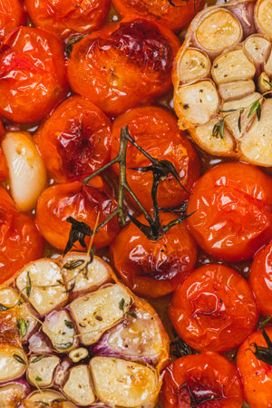 Cherry tomatoes baked with thyme and garlic cloveの写真素材