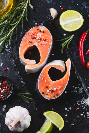 Raw salmon steaks with seasoningsの写真素材