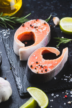 Raw salmon steaks with seasoningsの写真素材