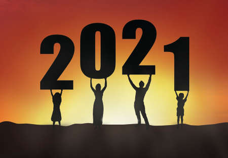 2021 silhouette of a family standing in the sunset, family empowerment, new year holiday greeting cardの写真素材