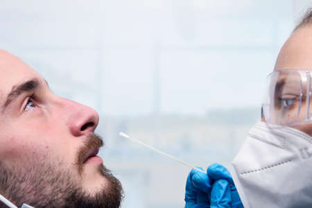 Healthcare makes PCR test on a suspected coronavirus patient, COVID-19, collection process nasal samples NP and OP oral, viral DNA diagnostic procedure RT-PCRの写真素材
