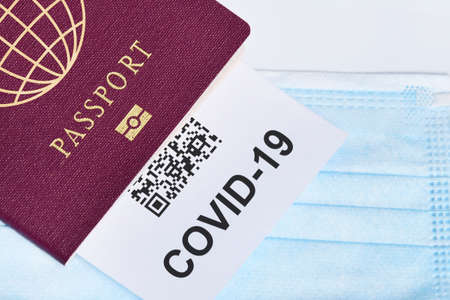COVID-19 and travel concept, mark of coronavirus PCR testing in tourist passport. Diagnostics of coronavirus in airport due to lockdown. Business and tourism hit by corona virus during pandemicの写真素材