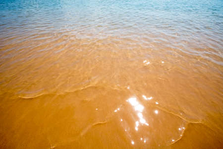 Soft wave of the sea on the sandy beach. Natural background.の写真素材