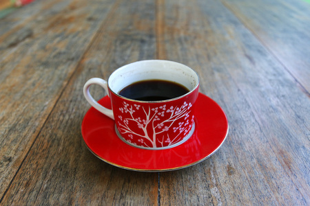 Black coffee in a red cup on a tableの写真素材