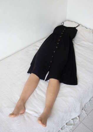 Black dress with human legs without headの写真素材