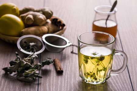 Still life with tea. Natural herbal tea with mentha, honey and lemon.の写真素材