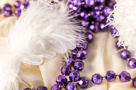 Christmas decorations with feather and necklace on satin backgroundの写真素材