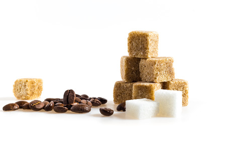 cane sugar cubes and coffee beans on a white backgroundの写真素材