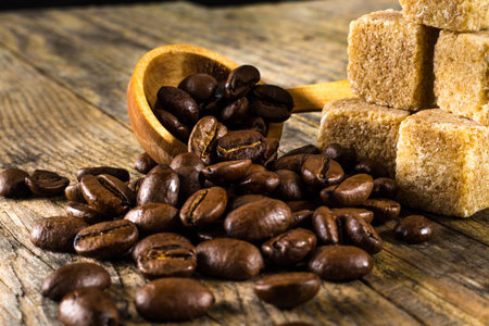 Closeup photo of coffee beans with cane sugar.