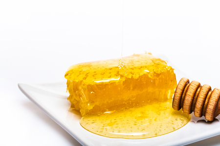 honey dipper,  honeycomb and nohey on the white backgroundの写真素材