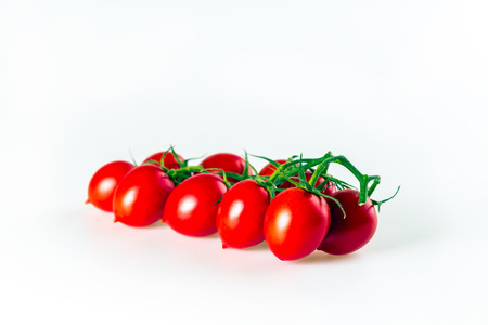 bunch of cherry tomatoes on a white backgroundの写真素材