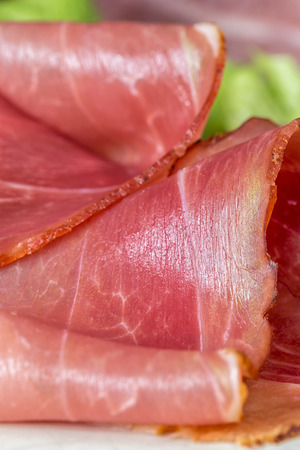 sliced and smoked ham with schwarzwald ham or prosciuttoの写真素材