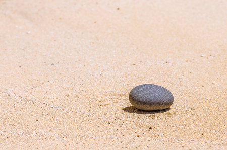 stones in the brown sand on the beachの写真素材