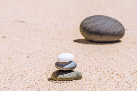 different stones in the brown sand on the beachの写真素材