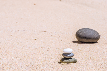 different stones in the brown sand on the beachの写真素材