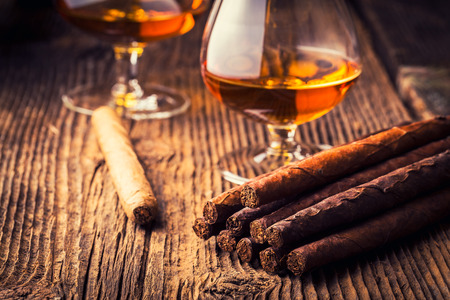 quality cigars and cognac on an old wooden tableの写真素材
