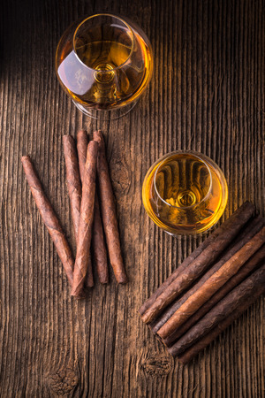 quality cigars and cognac on an old wooden tableの写真素材