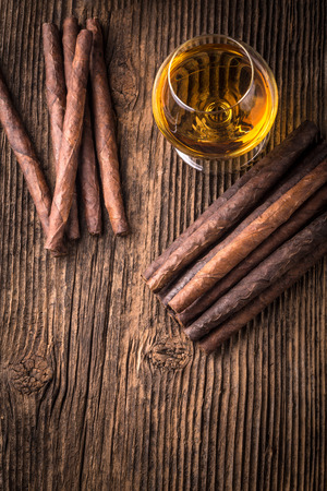 quality cigars and cognac on an old wooden tableの写真素材