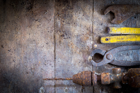 Old rusty tools in the workshop on an old wooden tableの写真素材