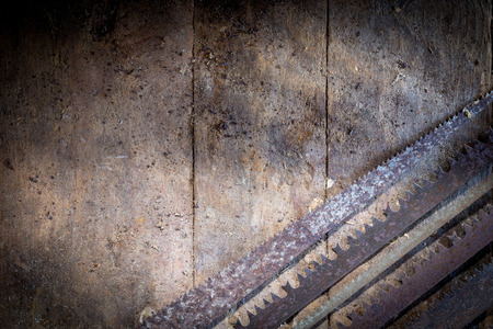 Old rusty saw blades on a wooden table in an old workshopの写真素材