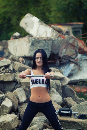 Pretty young fitness girl working out with dumbbell.の写真素材