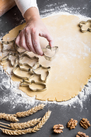 Cutting dough on different shapes, with steel cutters, on the black backgroundの写真素材