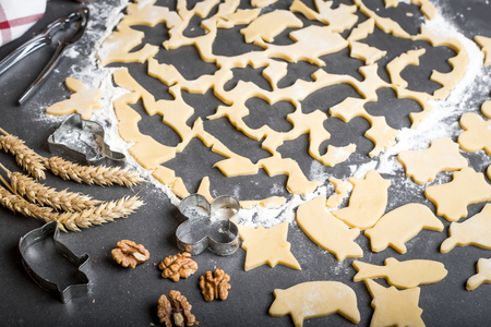 Cutting dough on different shapes, with steel cutters, on the black backgroundの写真素材