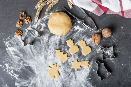 Cutting dough on different shapes, with steel cutters, on the black backgroundの写真素材
