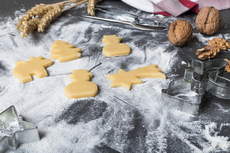 Cutting dough on different shapes, with steel cutters, on the black backgroundの写真素材