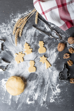 Cutting dough on different shapes, with steel cutters, on the black backgroundの写真素材