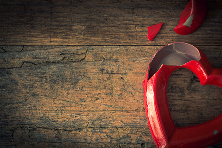 Valentine broken heart on a vintage wooden backgroundの写真素材